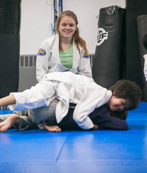 Two kids rolling Gi BJJ and instructor