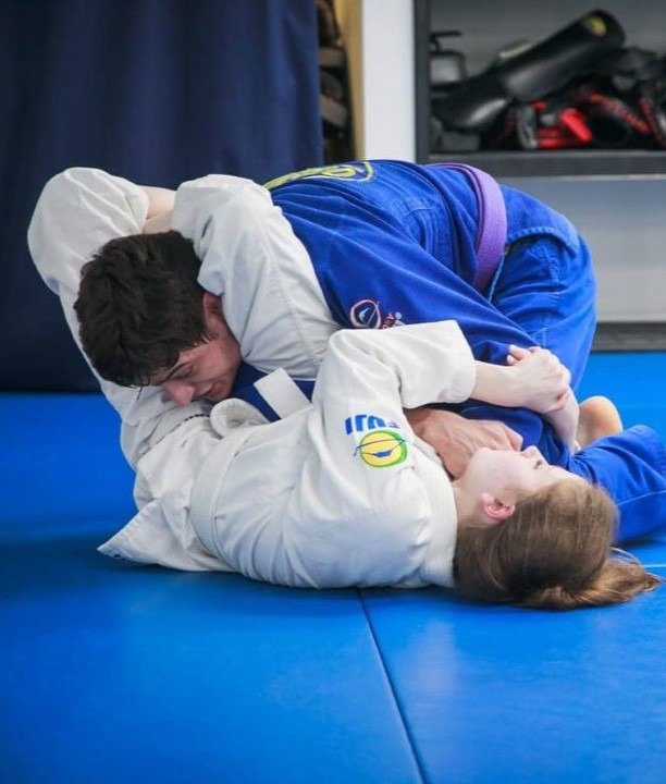 Kids BJJ triangle on instructor