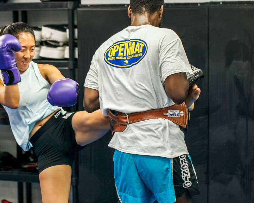 Instructor holding pads for muay thai