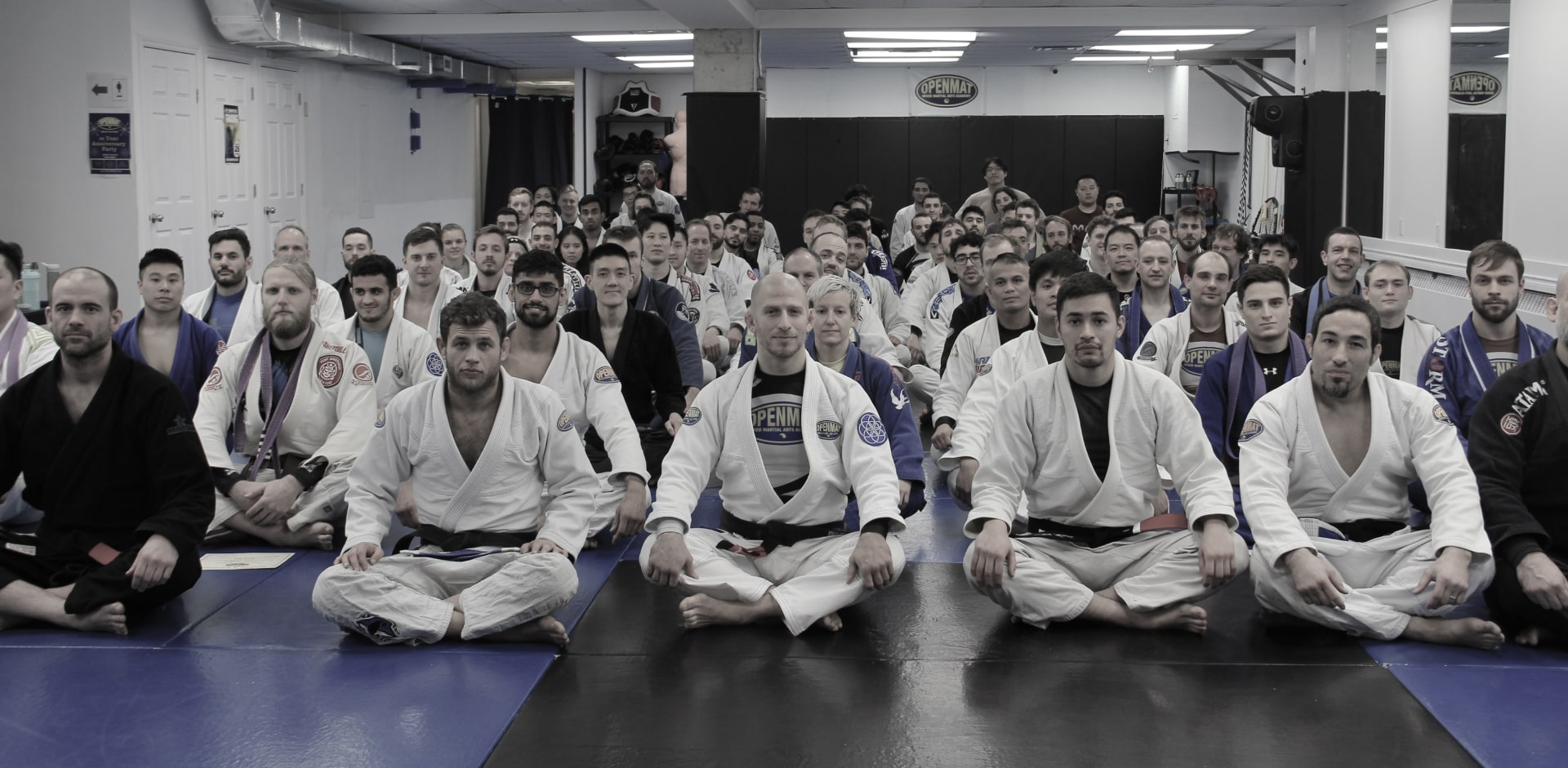 OpenMat MMA BJJ team sitting on mats